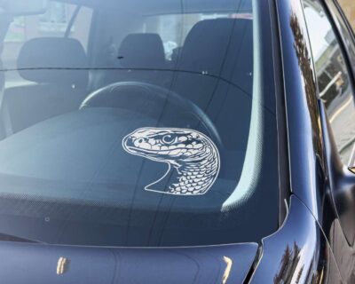 Silhouette of a snake's head with realistic detailed scales and beady eyes