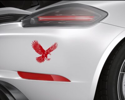 Striking black silhouette vinyl decal of a raven in mid-flight, wings spread wide and talons extended.