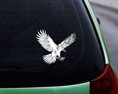 Striking black silhouette vinyl decal of a raven in mid-flight, wings spread wide and talons extended.