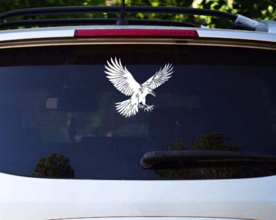 Striking black silhouette vinyl decal of a raven in mid-flight, wings spread wide and talons extended.