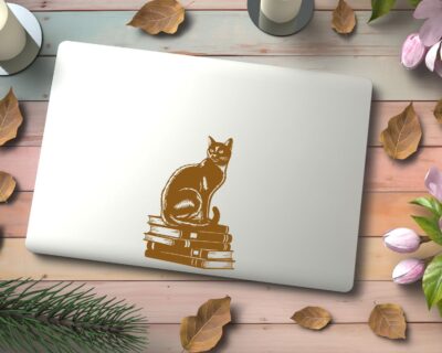 Vinyl decal of a cat sitting gracefully on a stack of books, rendered in a bold silhouette style.