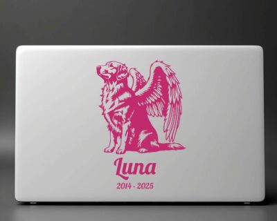 Vinyl decal of a majestic golden retriever dog with large angel wings. The dog is depicted sitting upright with a calm and serene expression, its head slightly tilted upward as if looking toward the heavens. Detailed fur markings create a textured, realistic look throughout the body, while the strong wings extend gracefully from its back, showcasing layered feathers with intricate line work.
